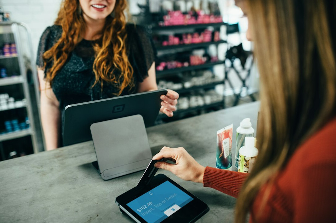 Receptionist managing a client queue on a tablet